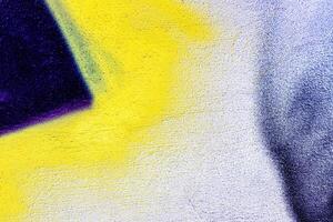 A fragment of colorful graffiti painted on a wall. Abstract urban background. photo