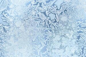 The texture of the glass covered with frost in winter in cold weather. Abstract background. photo