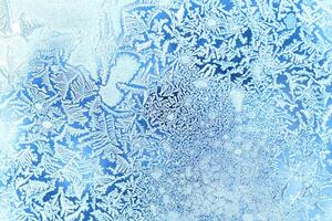 The texture of the glass covered with frost in winter in cold weather. Abstract background. photo