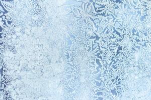 The texture of the glass covered with frost in winter in cold weather. Abstract background. photo