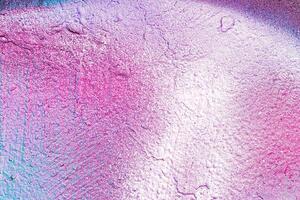 A fragment of colorful graffiti painted on a wall. Abstract urban background. photo