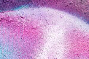 A fragment of colorful graffiti painted on a wall. Abstract urban background. photo