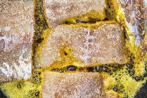 Breaded fish steaks, fried in a pan with vegetable oil. photo