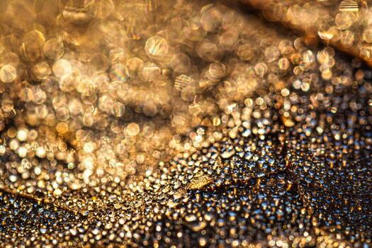 Dew drops on an autumn fallen leaf, shimmering in the sun, shot in close-up with bokeh. Abstract macro background. photo