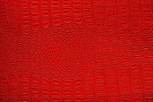 Red crocodile leather texture. Abstract backdrop for design. photo