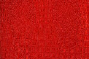 Red crocodile leather texture. Abstract backdrop for design. photo
