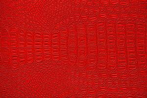 Red crocodile leather texture. Abstract backdrop for design. photo