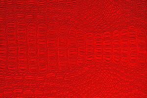 Red crocodile leather texture. Abstract backdrop for design. photo