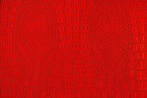 Red crocodile leather texture. Abstract backdrop for design. photo