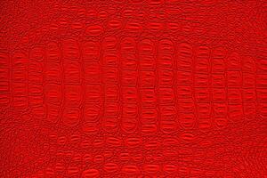 Red crocodile leather texture. Abstract backdrop for design. photo