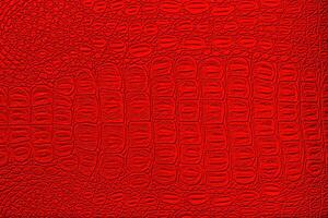 Red crocodile leather texture. Abstract backdrop for design. photo