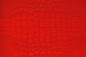 Red crocodile leather texture. Abstract backdrop for design. photo