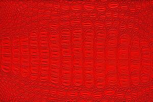 Red crocodile leather texture. Abstract backdrop for design. photo