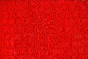 Red crocodile leather texture. Abstract backdrop for design. photo