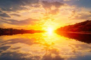 Sunset on the river at summer evening with clouds and trees. Water reflection of a sky. photo