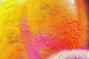 A fragment of colorful graffiti painted on a wall. Abstract urban background. photo