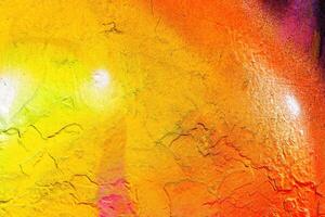 A fragment of colorful graffiti painted on a wall. Abstract urban background. photo
