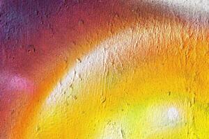 A fragment of colorful graffiti painted on a wall. Abstract urban background. photo