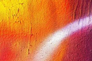 A fragment of colorful graffiti painted on a wall. Abstract urban background. photo