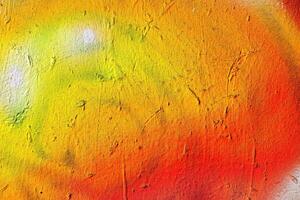 A fragment of colorful graffiti painted on a wall. Abstract urban background. photo