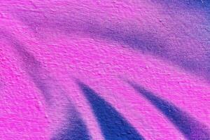 A fragment of colorful graffiti painted on a wall. Abstract urban background. photo