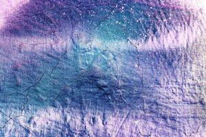 A fragment of colorful graffiti painted on a wall. Abstract urban background. photo