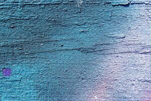 A fragment of colorful graffiti painted on a wall. Abstract urban background. photo