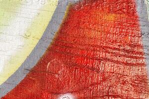 A fragment of colorful graffiti painted on a wall. Abstract urban background. photo