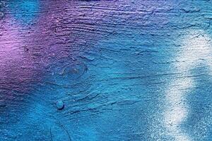 A fragment of colorful graffiti painted on a wall. Abstract urban background. photo