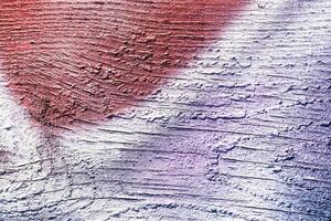 A fragment of colorful graffiti painted on a wall. Abstract urban background. photo