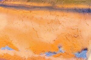 A fragment of colorful graffiti painted on a wall. Abstract urban background. photo