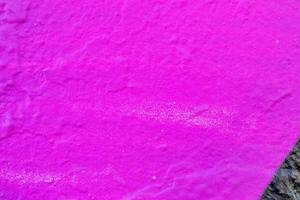 A fragment of colorful graffiti painted on a wall. Abstract urban background. photo