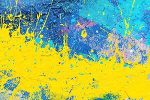 A fragment of colorful graffiti painted on a wall. Abstract urban background. photo