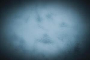 Blured monochrome decorative plaster or concrete background with vignette. photo