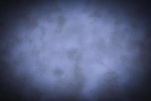 Blured monochrome decorative plaster or concrete background with vignette. photo