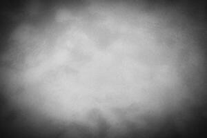 Gray decorative plaster or concrete background with vignette. photo