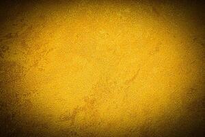 Texture of golden decorative plaster or concrete with vignette. photo