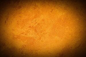 Texture of orange decorative plaster or concrete with vignette. photo