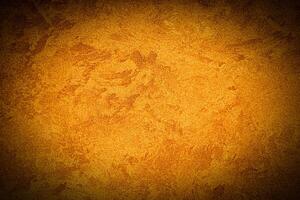 Texture of orange decorative plaster or concrete with vignette. photo