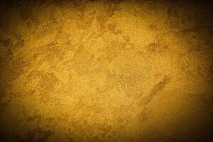 Texture of golden decorative plaster or concrete with vignette. photo