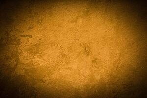 Texture of golden decorative plaster or concrete with vignette. photo