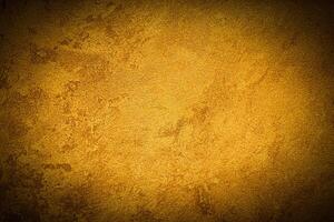 Texture of golden decorative plaster or concrete with vignette. photo