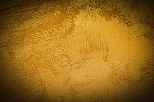 Texture of golden decorative plaster or concrete with vignette. photo