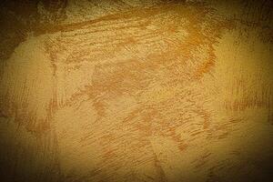 Texture of golden decorative plaster or concrete with vignette. photo