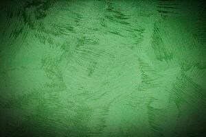 Texture of green decorative plaster or concrete with vignette. photo