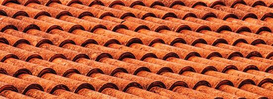 Texture of red clay roof tiles. Abstract backdrop for design. photo
