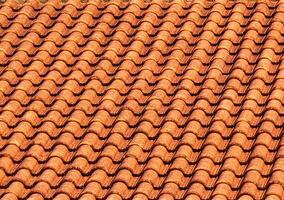 Texture of red clay roof tiles. Abstract backdrop for design. photo