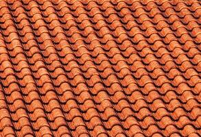 Texture of red clay roof tiles. Abstract backdrop for design. photo
