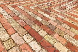 Old cobblestone pavement texture. Ancient sidewalk background. photo