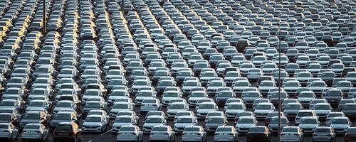 Volkswagen Group Rus, Russia, Kaluga - MAY 25, 2020 Rows of a new cars parked in a distribution center on a sunny morning in the autumn. photo